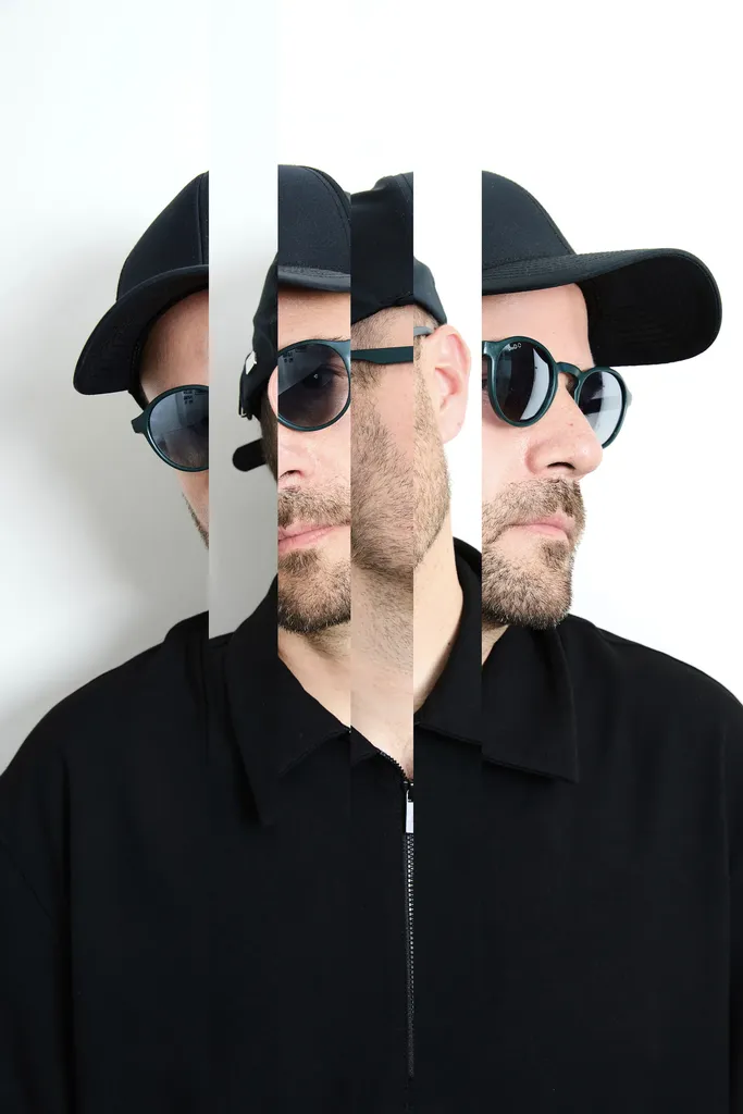 Colour portrait of a man in a black cap, round glasses and a black shirt, cut into vertical strips that show the same face from the front and in profile, on a white ground.